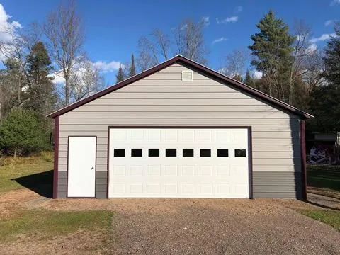 A large garage with a white garage door and a white door.