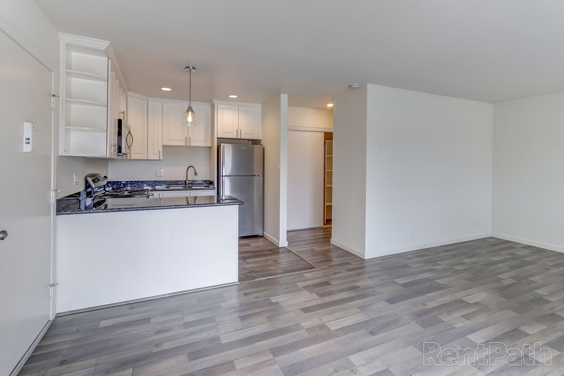 There is a kitchen and a living room in the apartment.