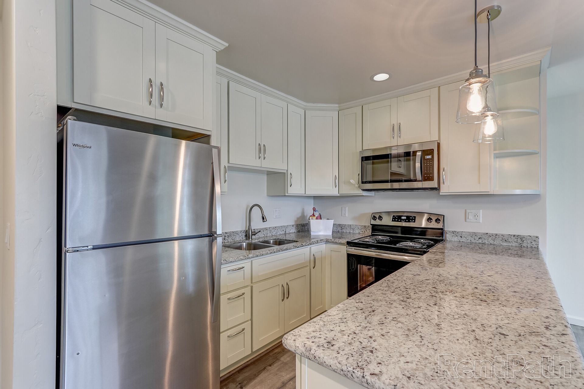 A kitchen with stainless steel appliances and granite counter tops