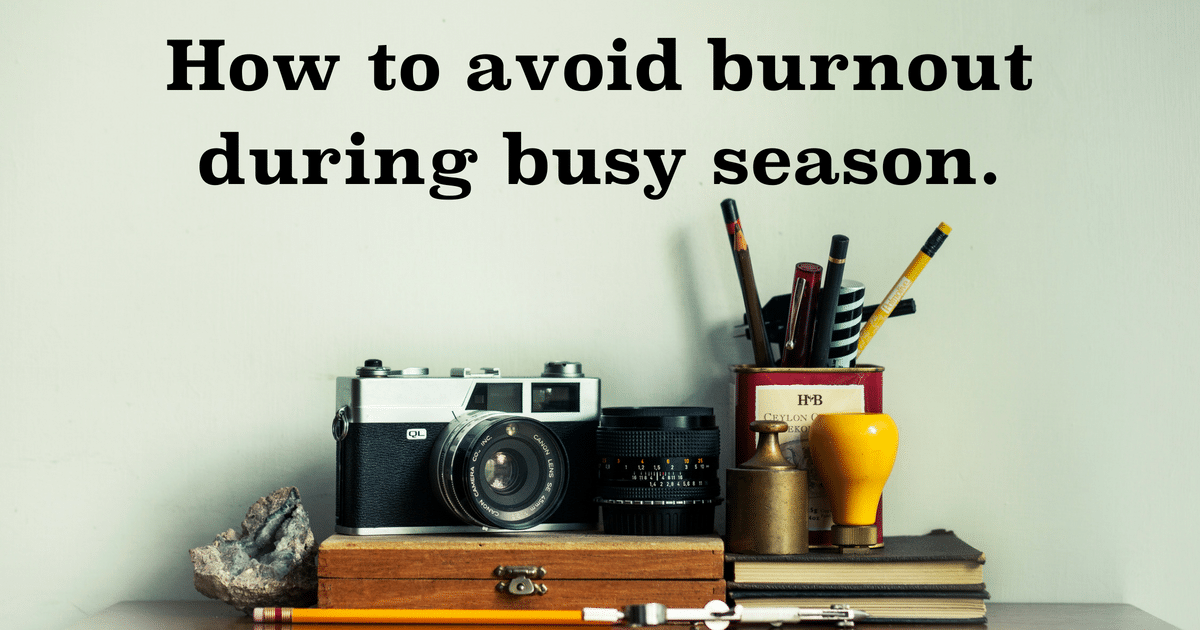 A camera is sitting on a desk with a sign that says how to avoid burnout during busy season