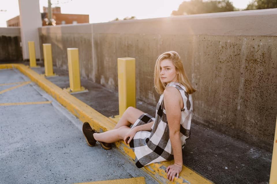 girl sitting in parking garage