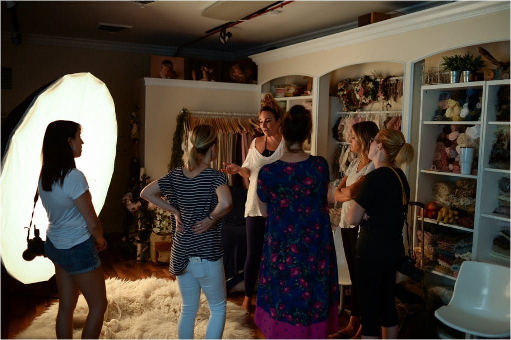 A group of women are standing in a circle in a room.