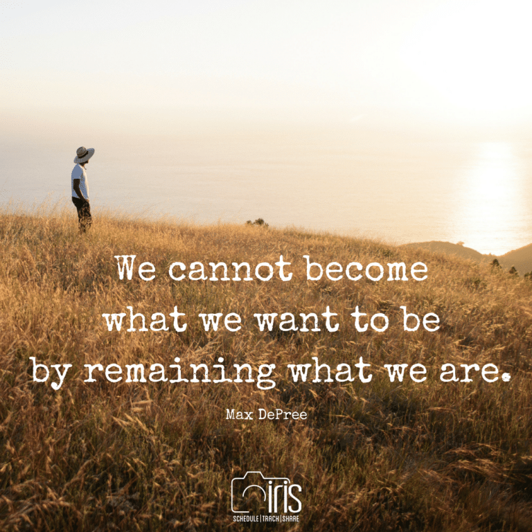 A man is standing in a field with a quote on it.