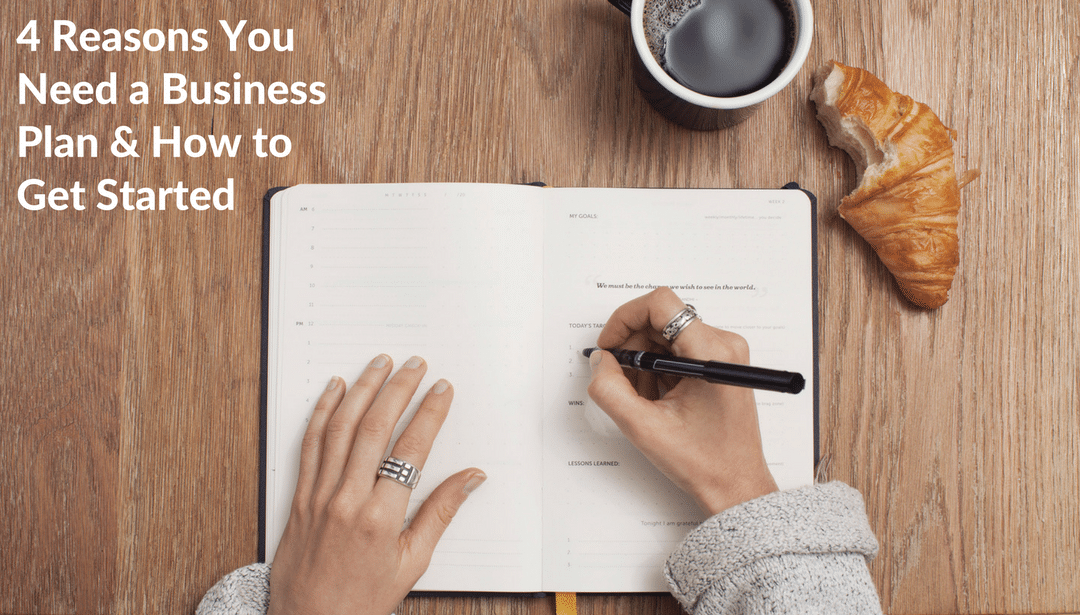 A person is writing in a notebook on a wooden table.