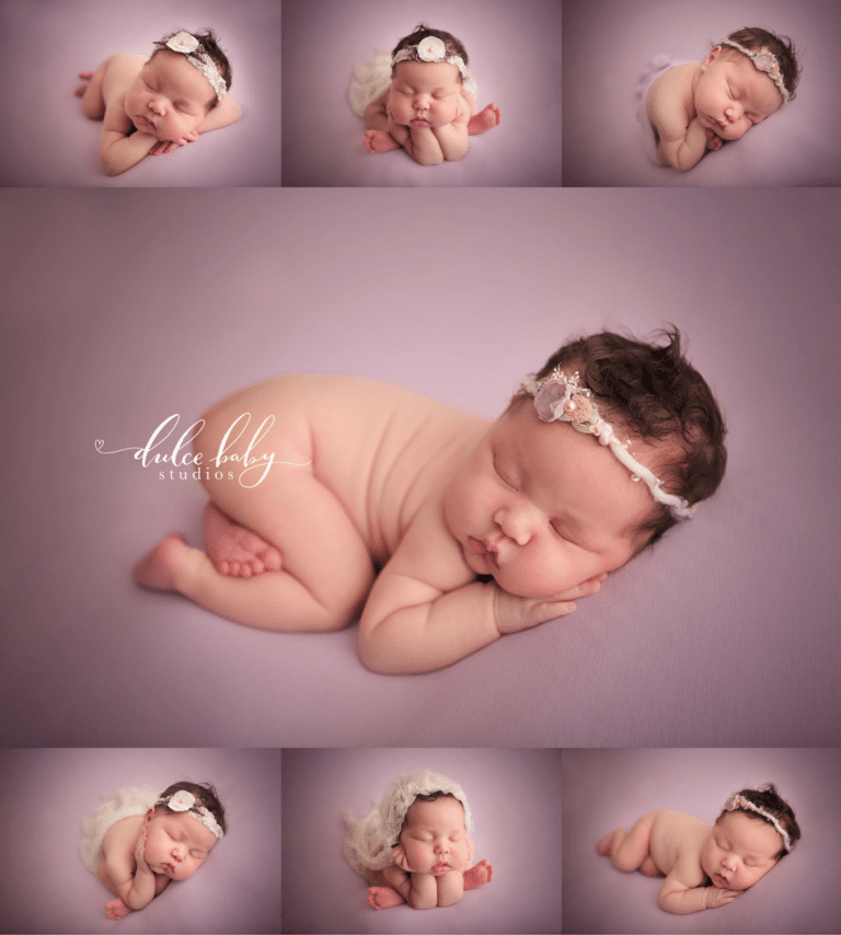 A newborn baby is laying on a purple blanket