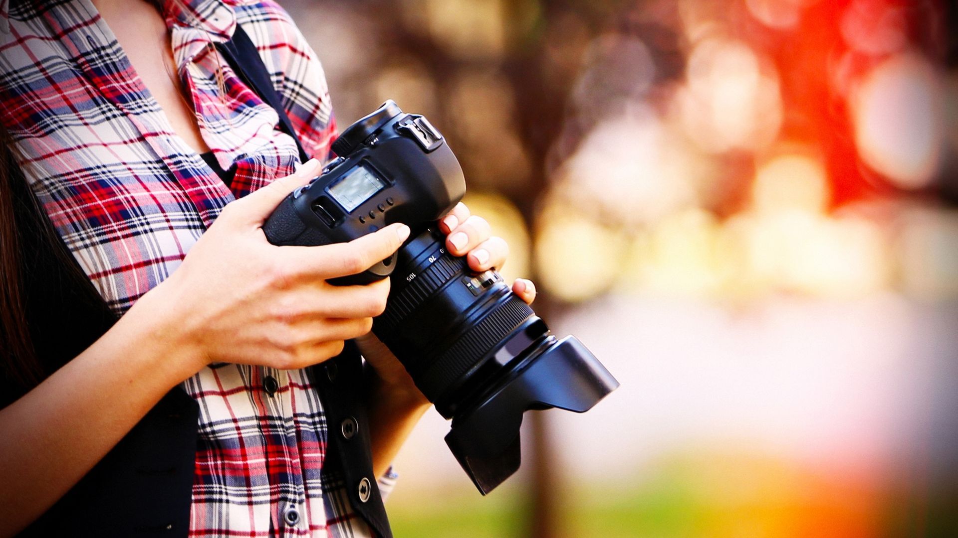 young photographer taking photos outdoors