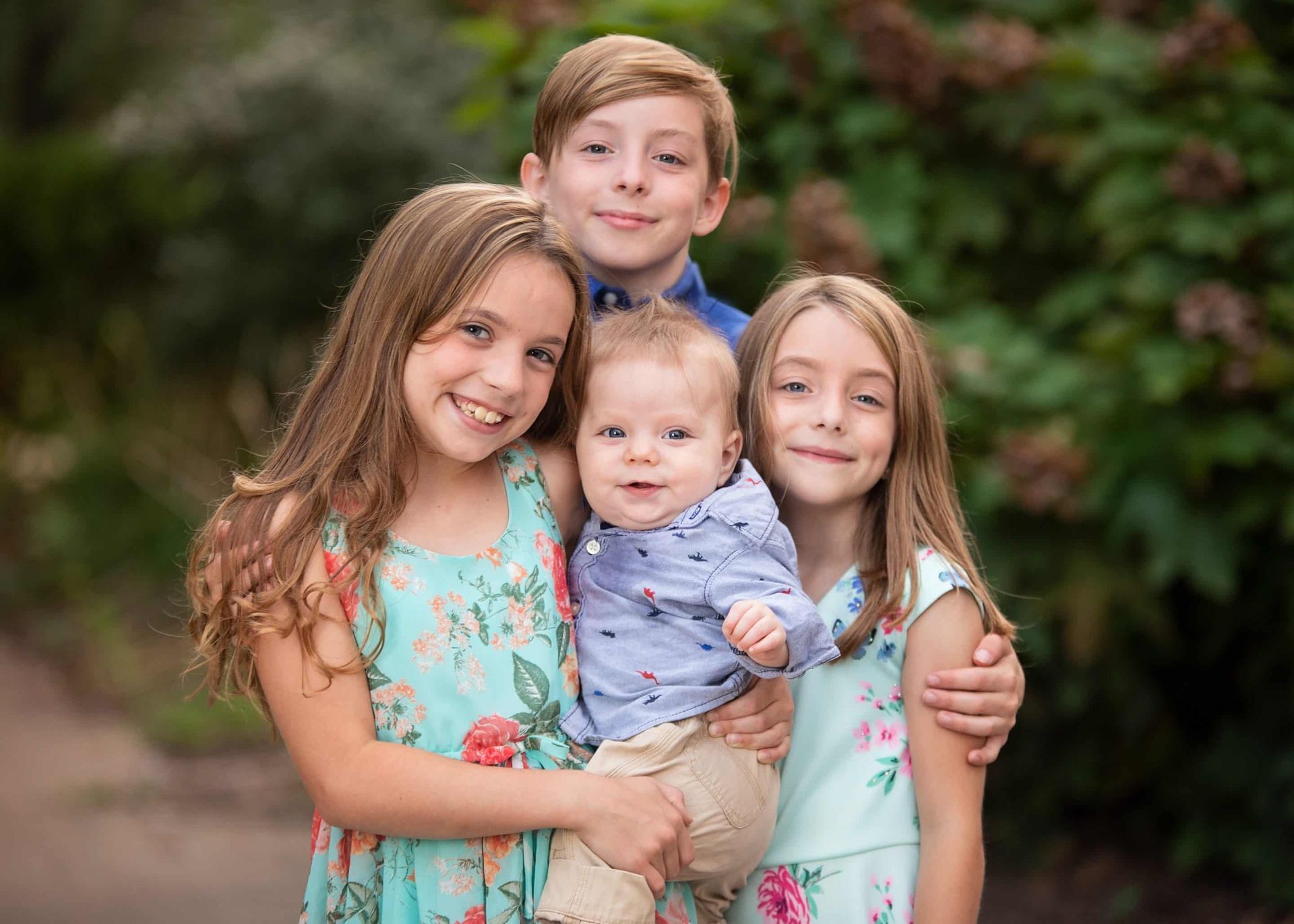 A group of children are posing for a picture together.