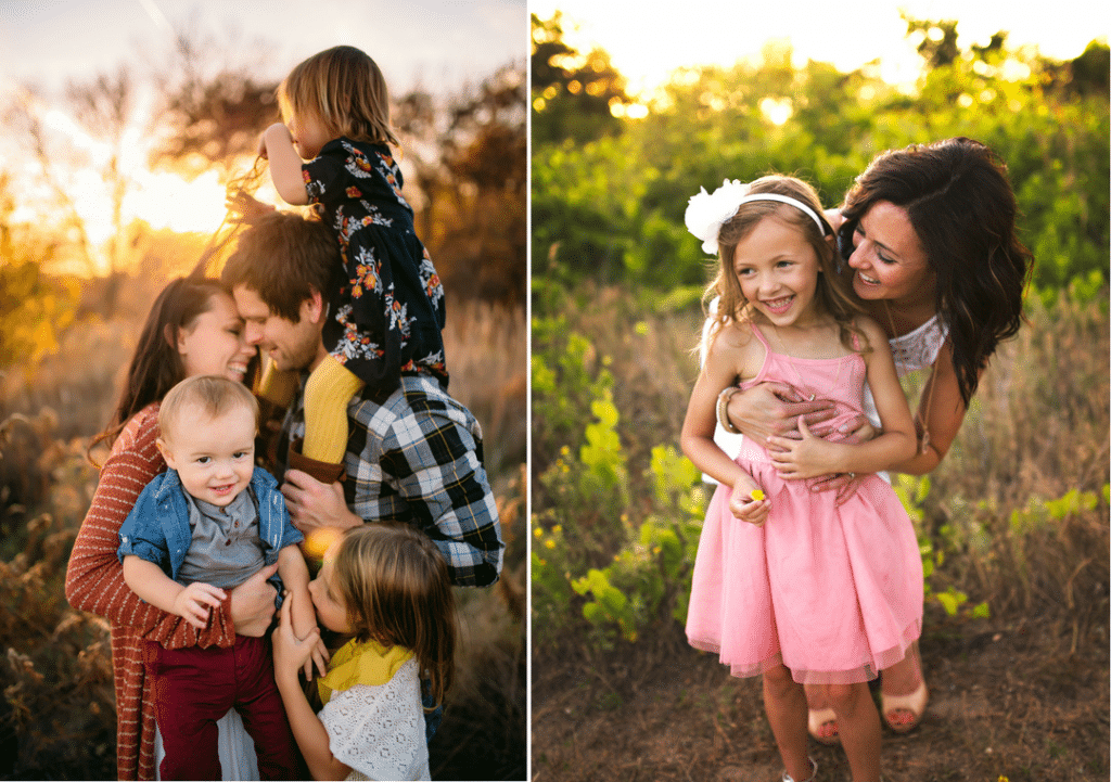 A man and a woman are holding their children in a field.