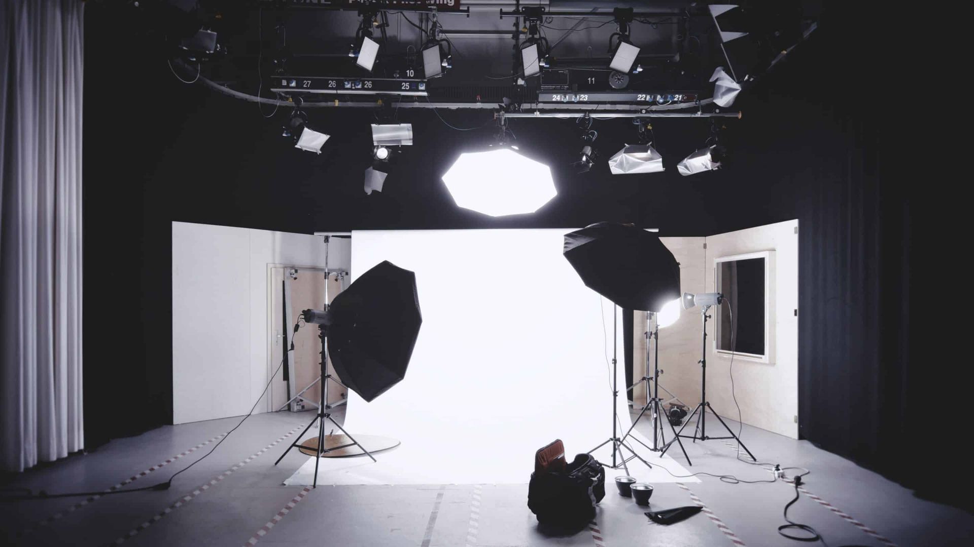 A person is laying on the floor in a photo studio.