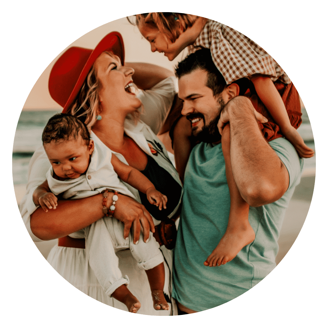 A family is posing for a picture on the beach.