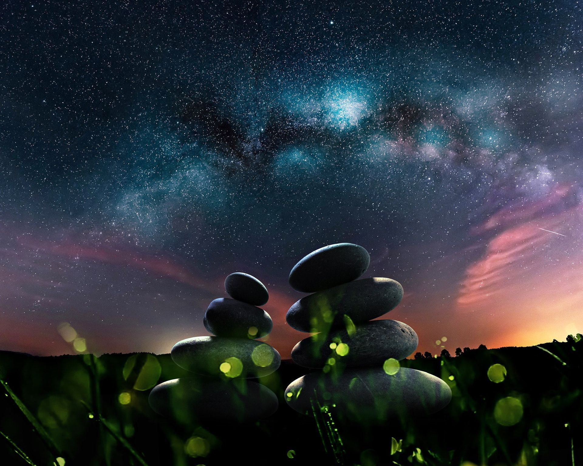 A stack of rocks under a starry night sky