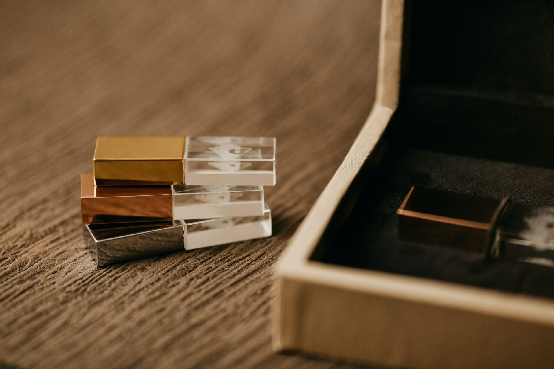 A stack of glass blocks sitting on top of a wooden table next to a box.