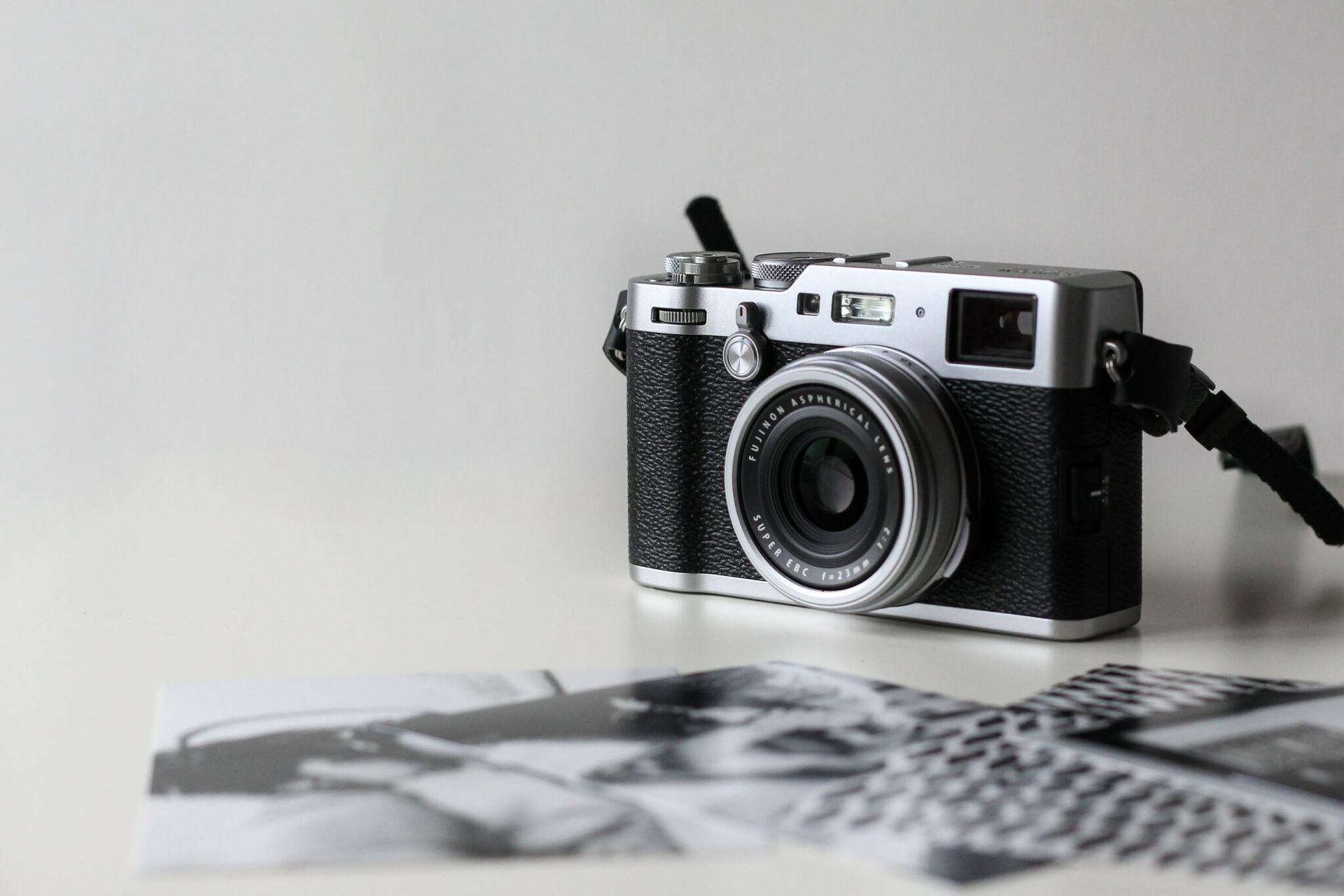 A camera is sitting on top of a piece of paper on a table.