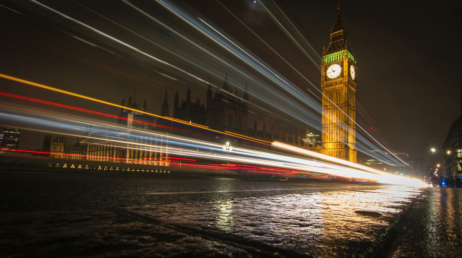 The big ben clock tower is lit up at night in london.