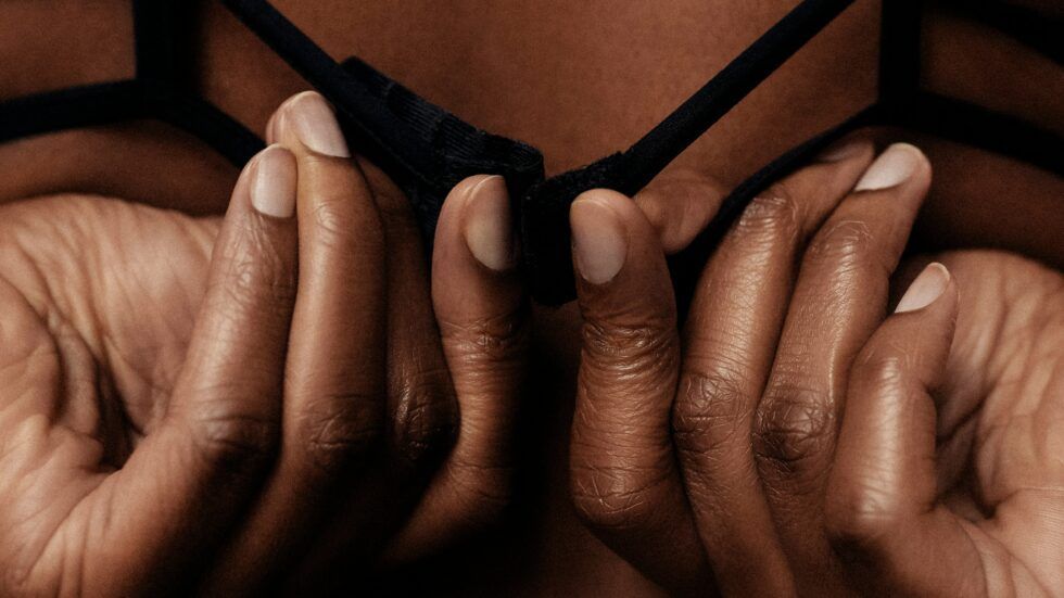 A close up of a woman 's hands holding a bra.