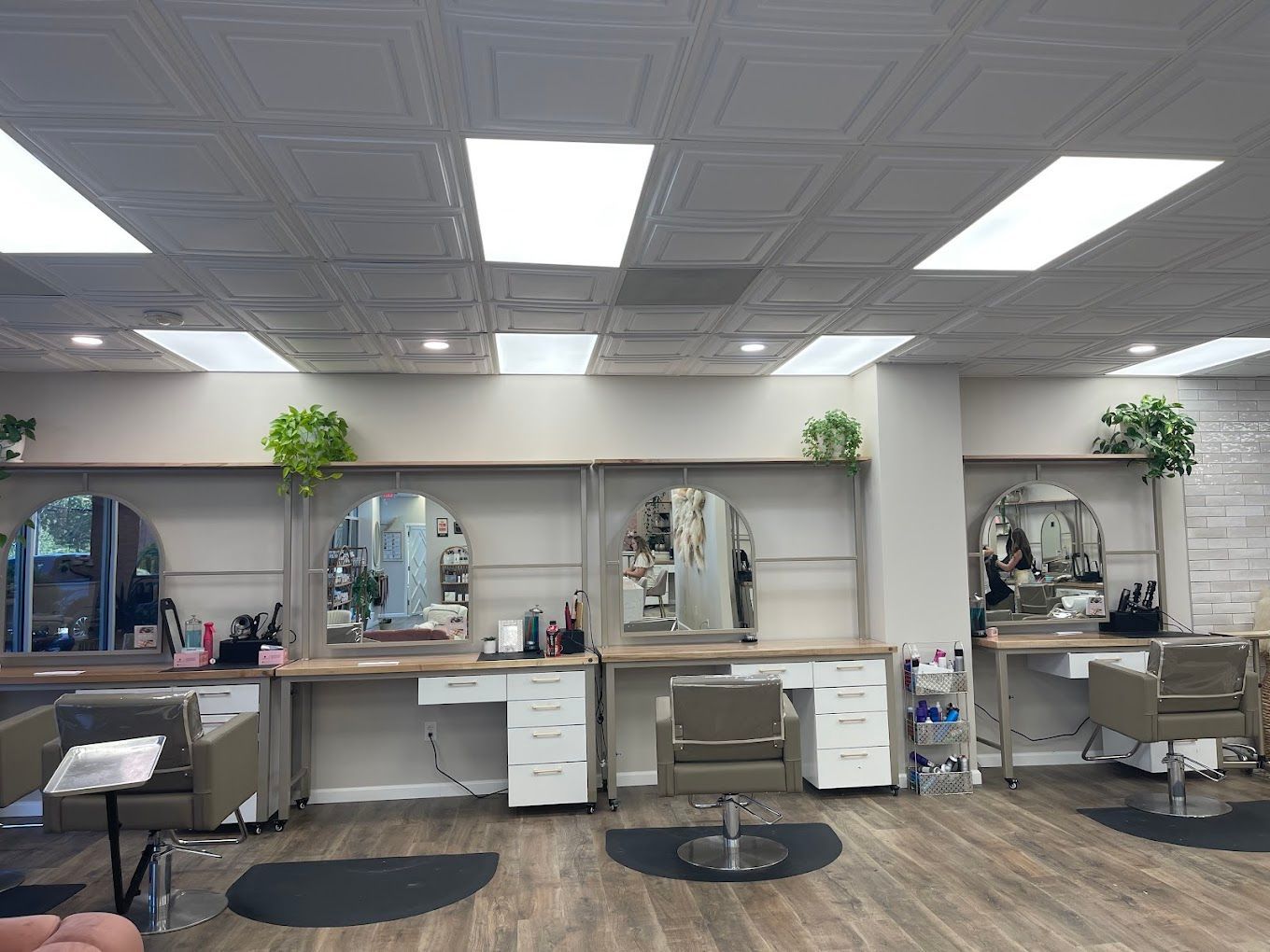 A hair salon with a lot of chairs and mirrors.