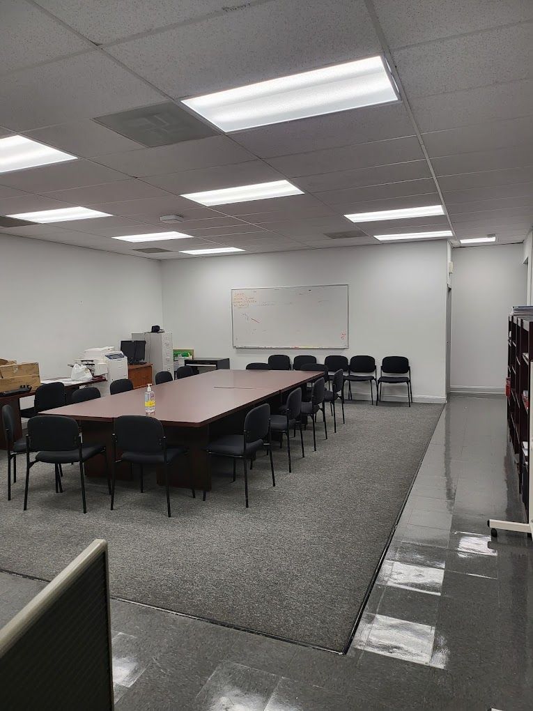 A conference room with a long table and chairs