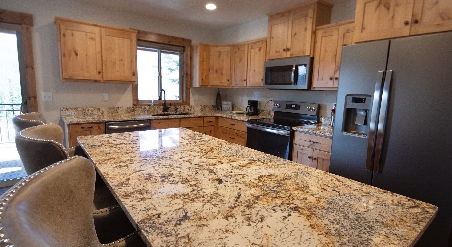 A kitchen with granite counter tops and stainless steel appliances