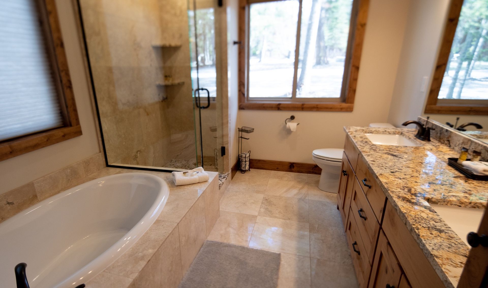 A bathroom with a tub , sink , toilet and shower.