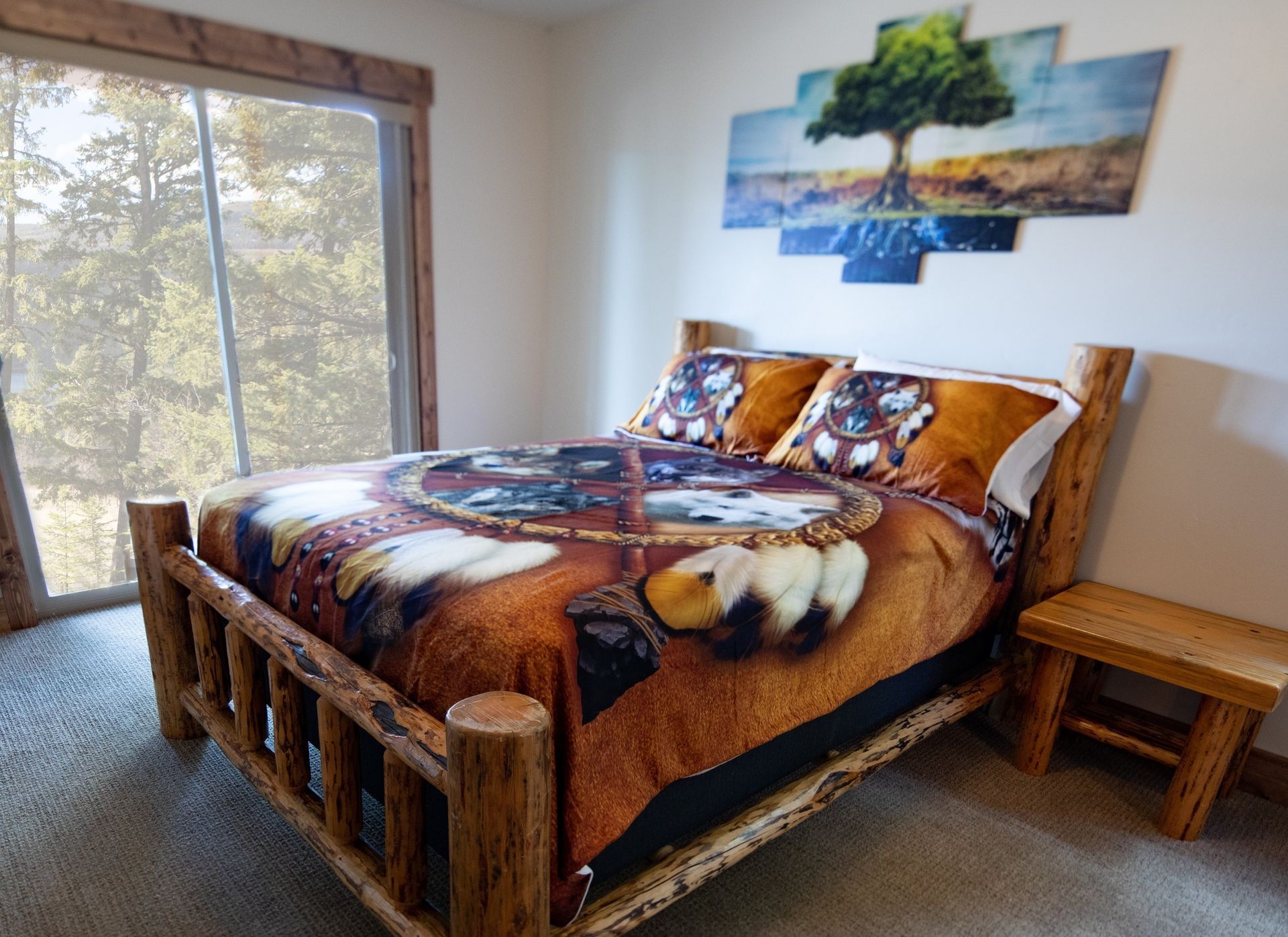 A bedroom with a log bed and a painting on the wall above it.