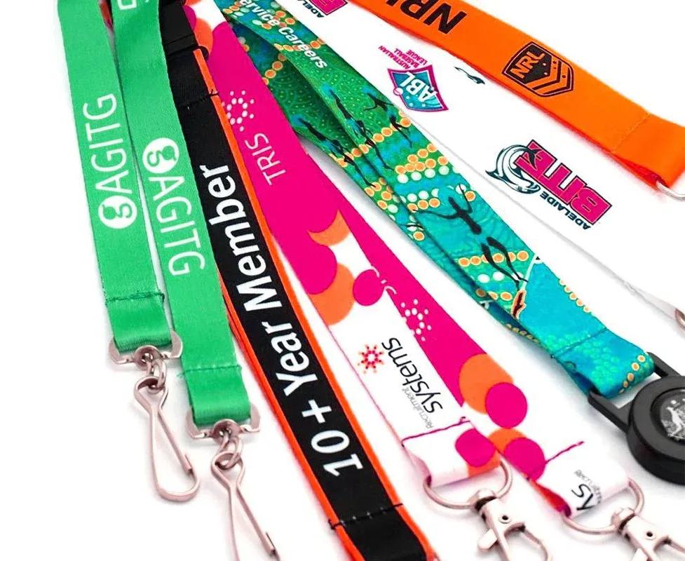 Variety of colorful lanyards with logos and text, including green, black, pink, and orange.