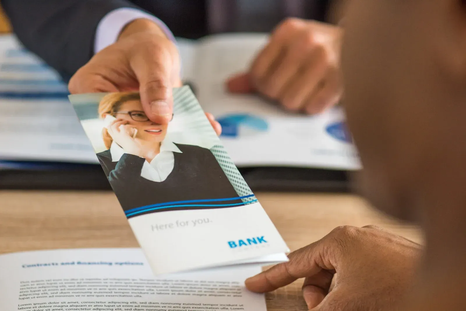 Papers, calculator, and paint samples related to home buying: reasons, checklist, and sales report.