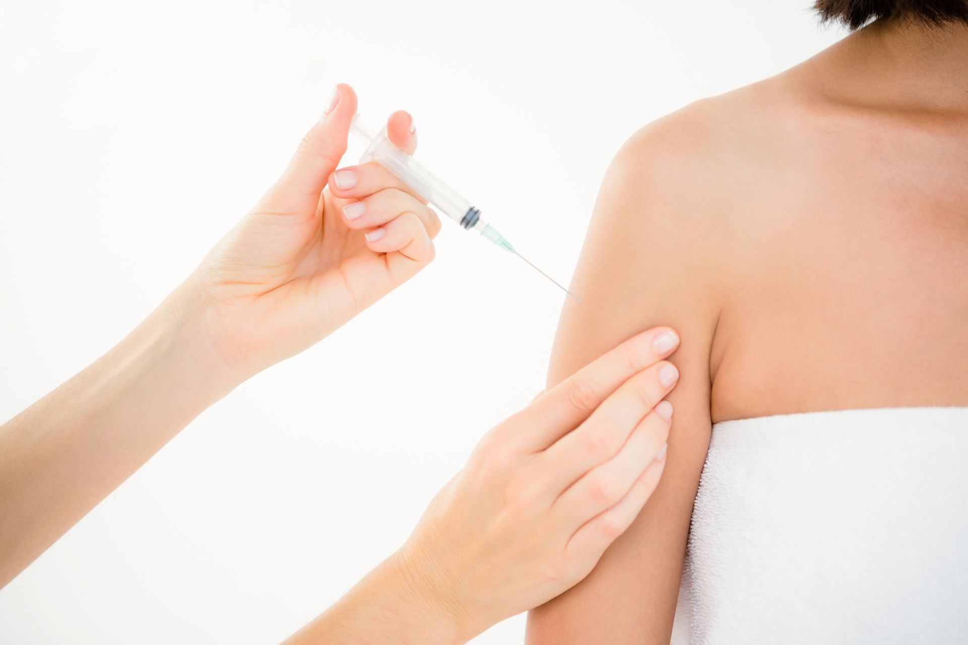 A woman is getting an injection in her arm.