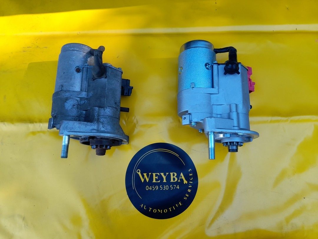 Two Starter Motors Are Sitting On A Yellow Cloth Next To A Weyba Logo — Weyba Automotive Services In Maroochydore, QLD
