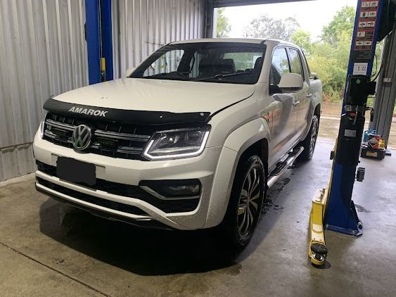 A White Volkswagen Amarok Is Parked In A Garage On A Lift — Weyba Automotive Services In Kuluin, QLD