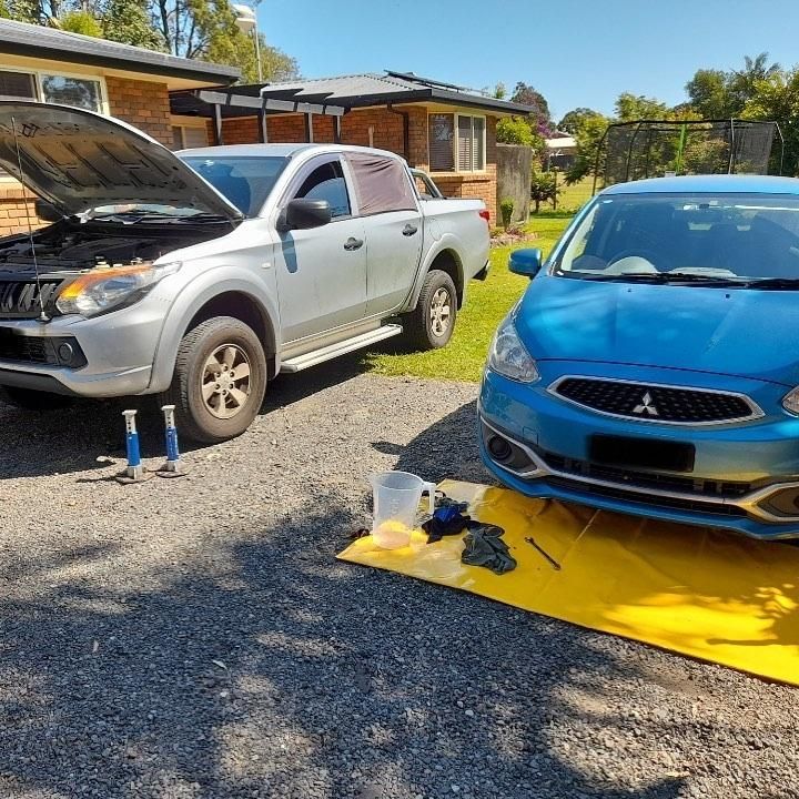 A Silver Truck And A Blue Car Are Parked Next To Each Other — Weyba Automotive Services In Kuluin, QLD