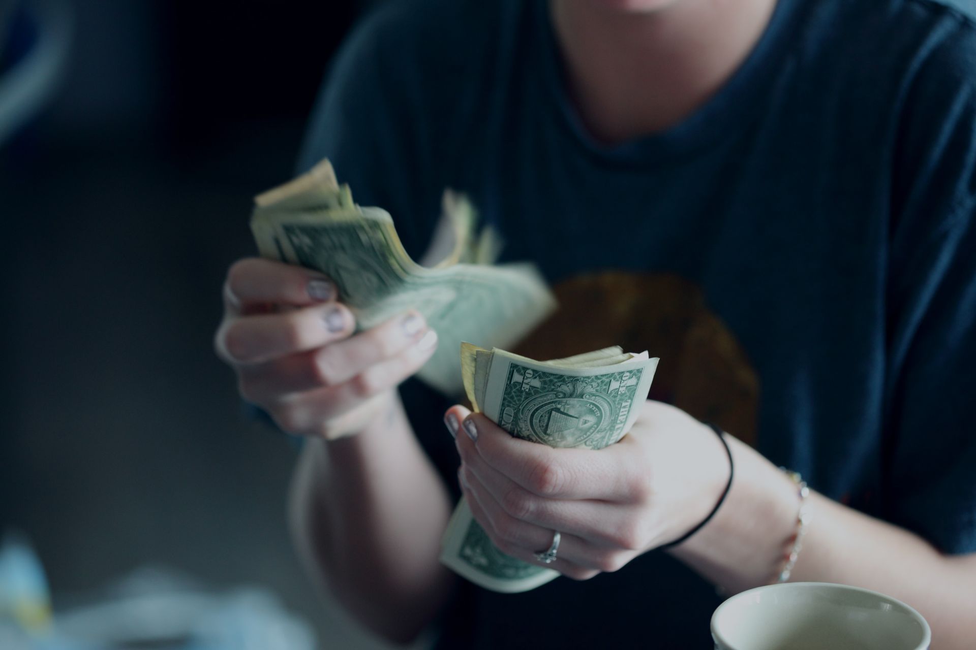 Woman counting American currency.