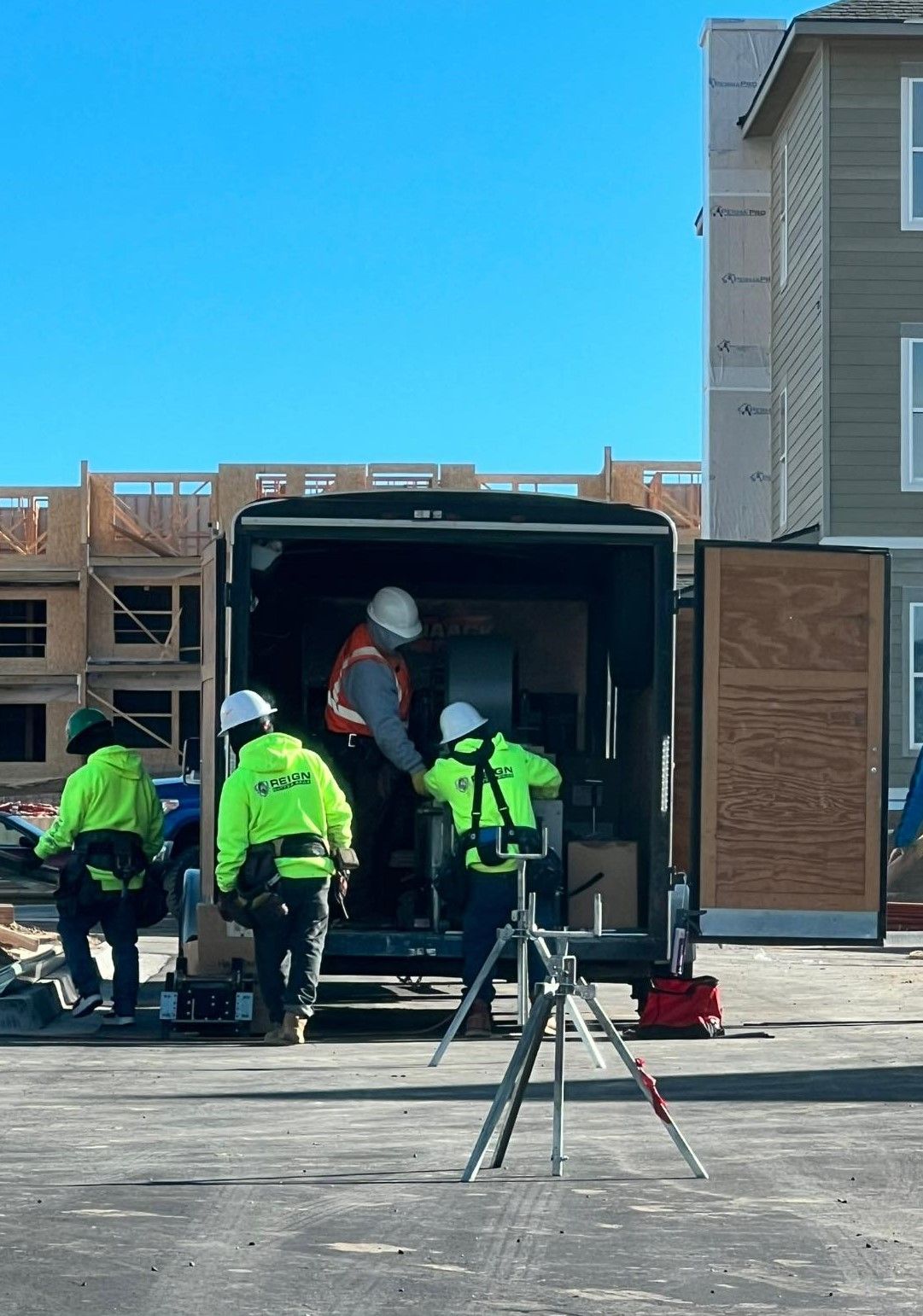 A group of construction workers are getting out of a trailer