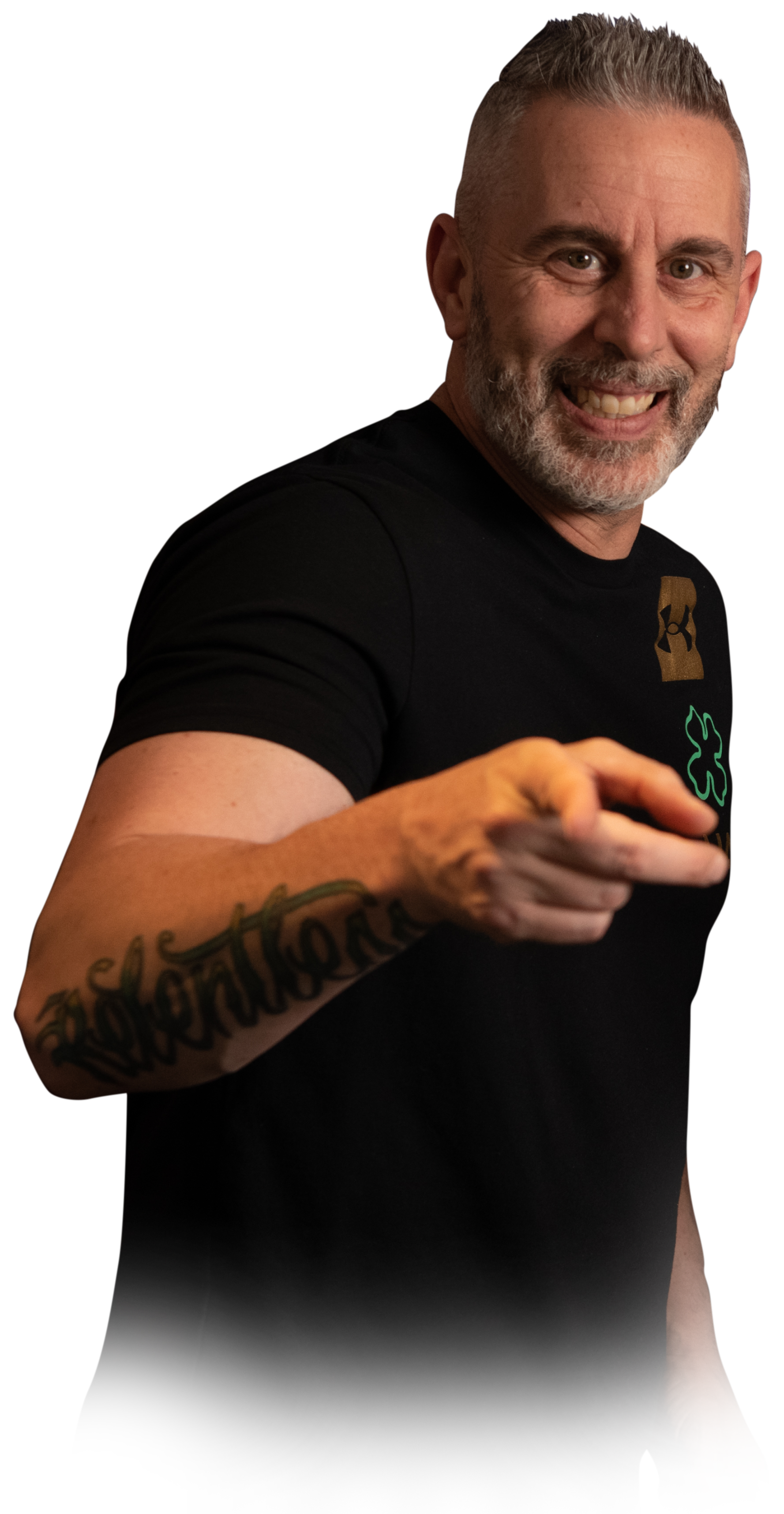 A man with a tattoo on his arm is pointing at the camera.