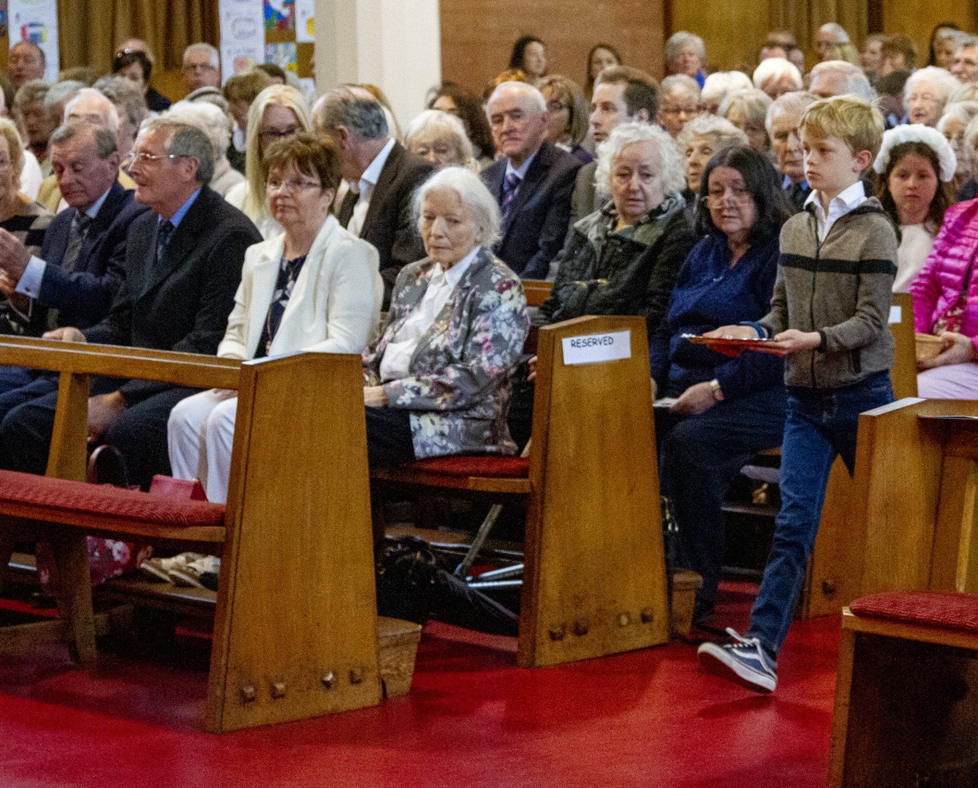 A large group of people are sitting in a church.
