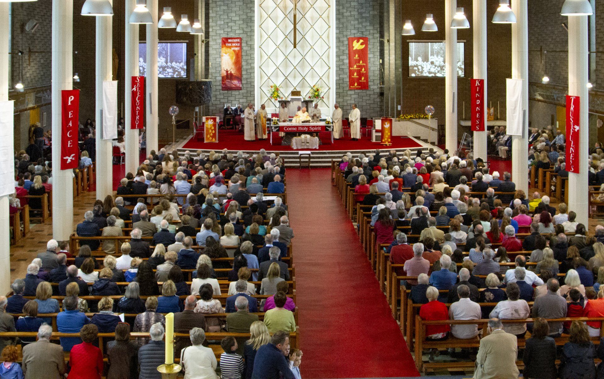 A large group of people are sitting in a church.
