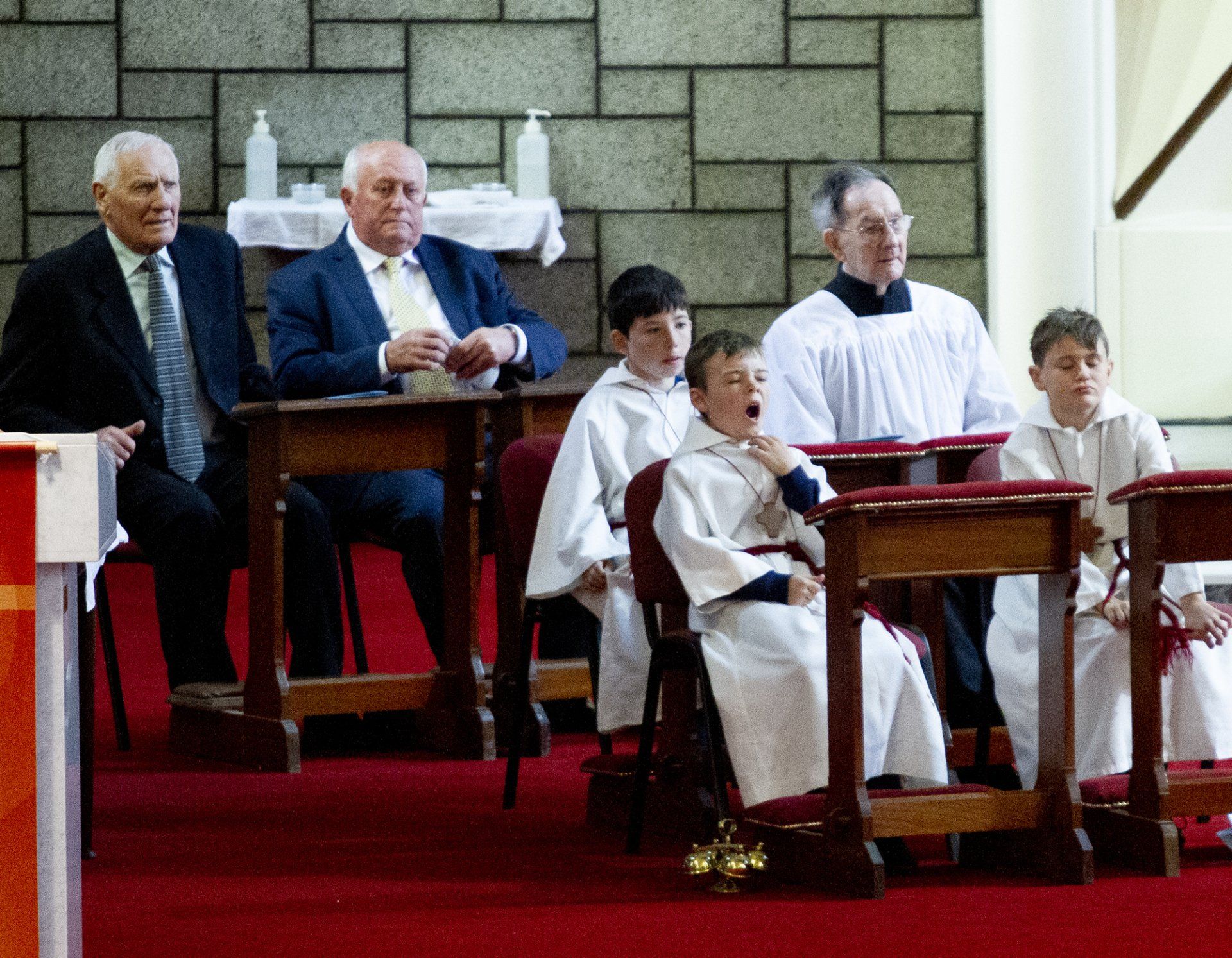 A group of people are sitting at tables in a church.