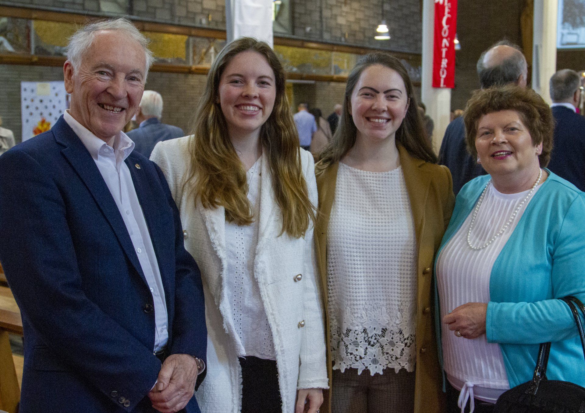 A group of people are posing for a picture together and smiling.