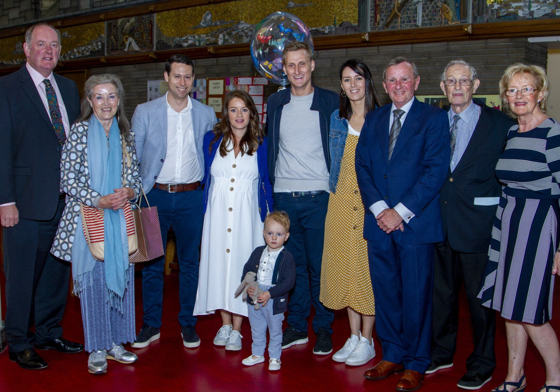 A large family is posing for a picture together.