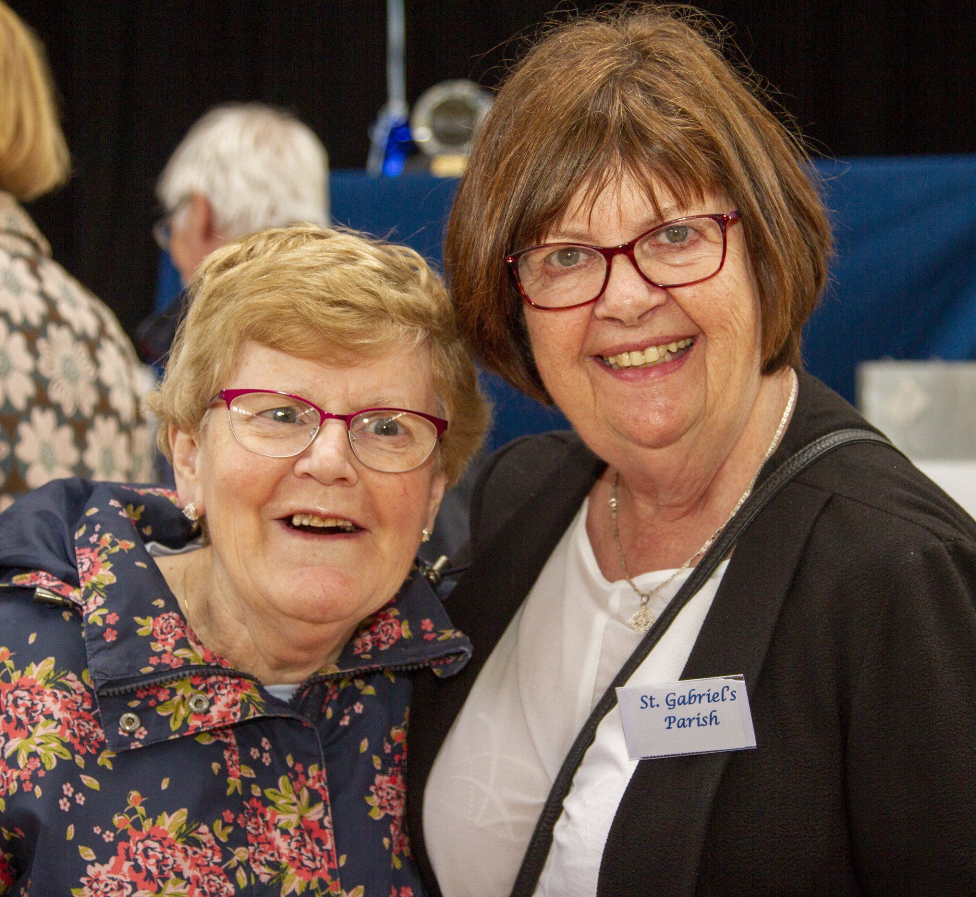 Two older women are posing for a picture and one has a name tag that says dr samuel tord