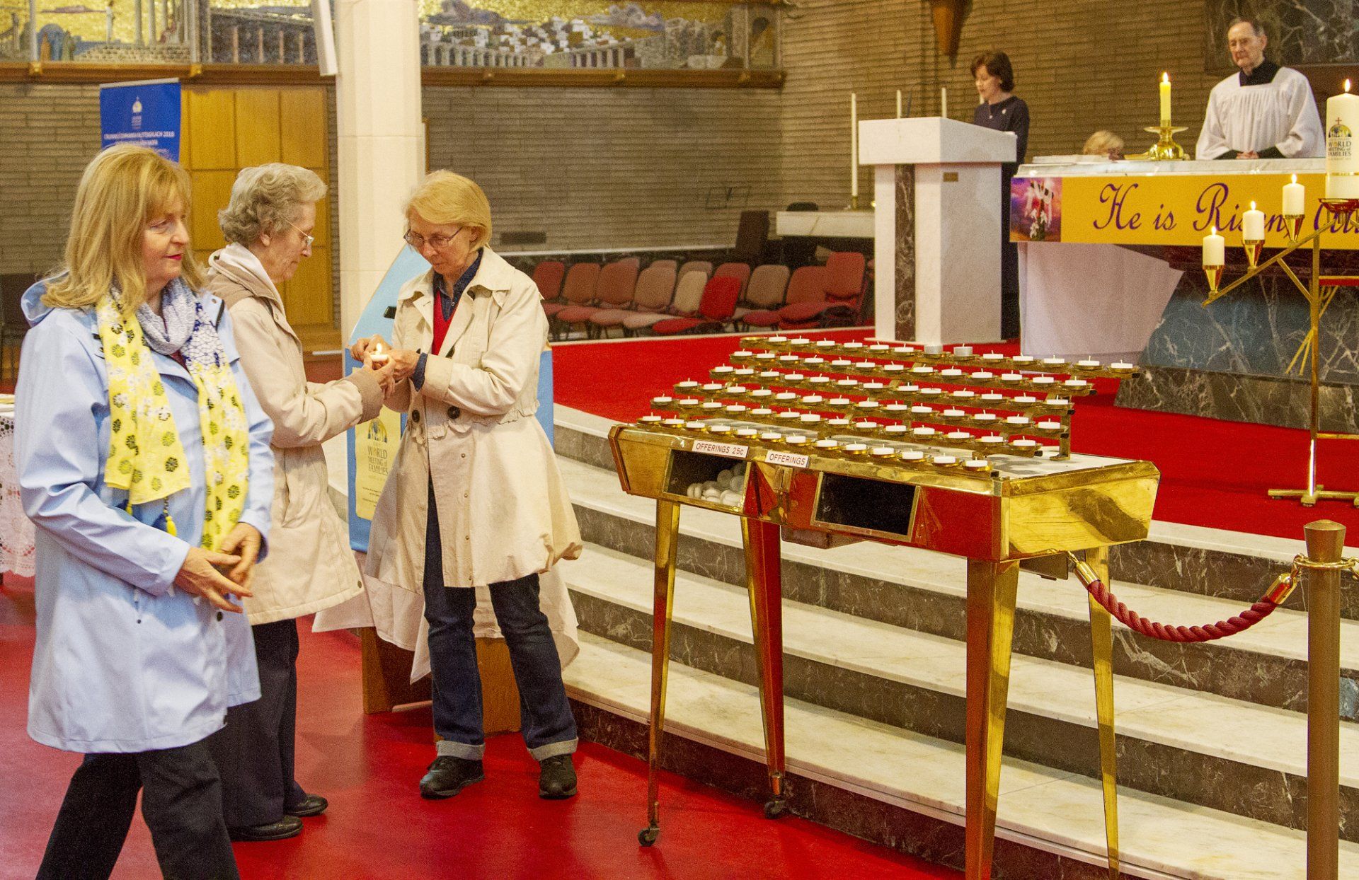 A group of women are standing in a church with a sign that says resurrection
