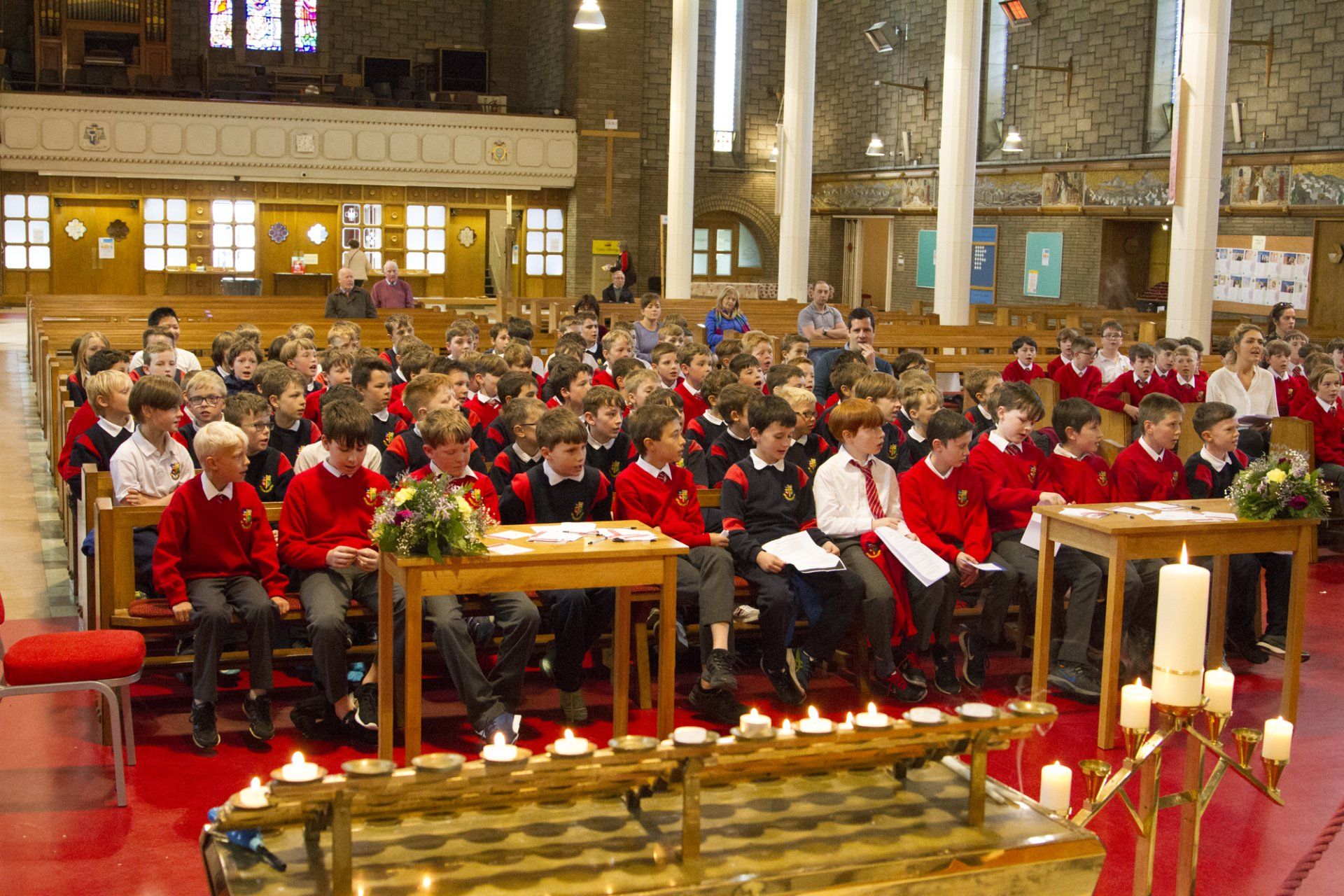 A large group of children are sitting in a church