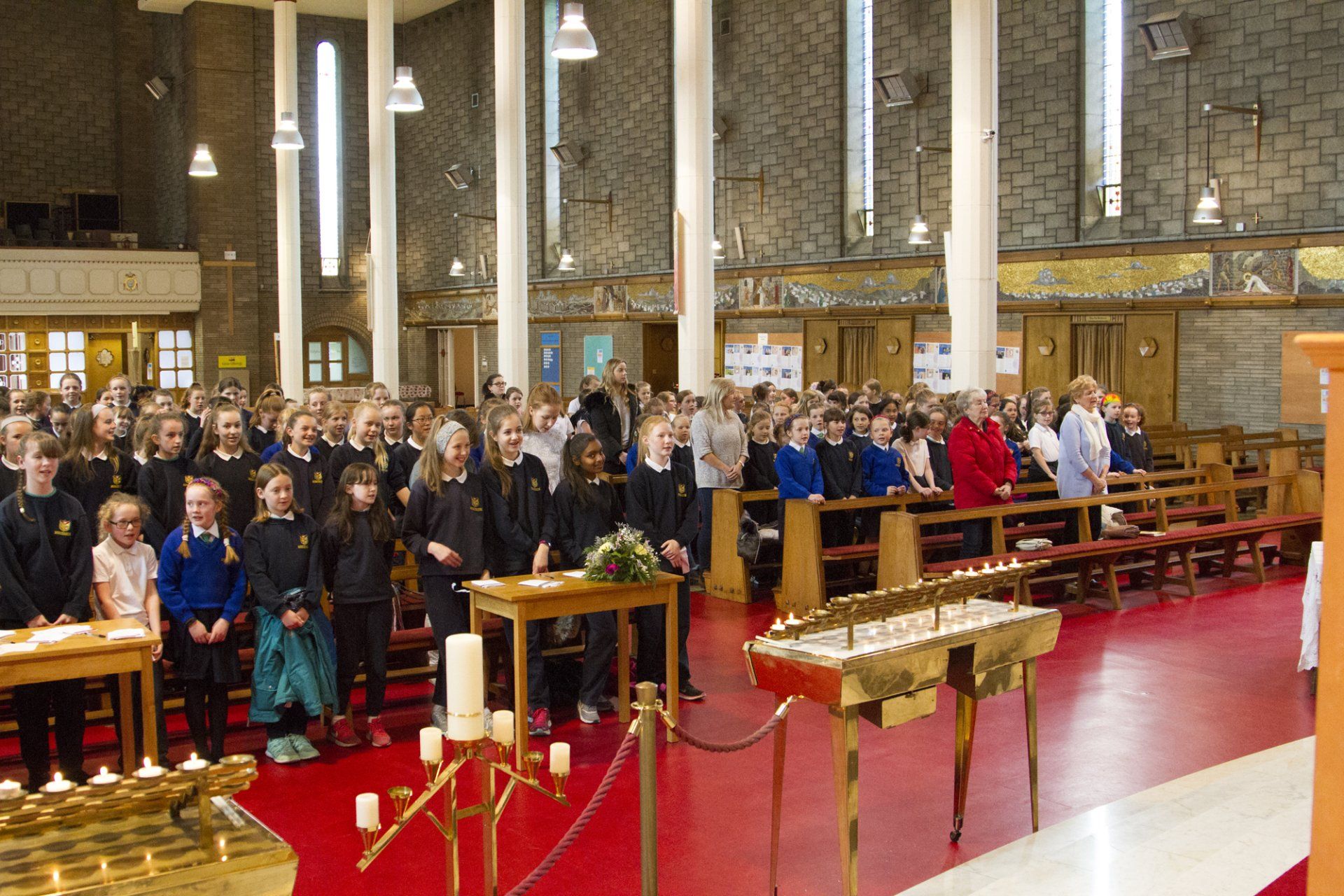 A large group of people are standing in a church.