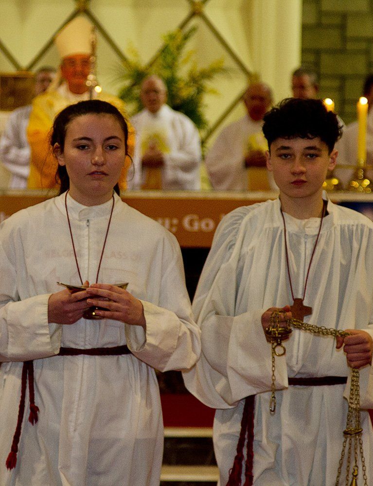 A boy and a girl are standing next to each other in a church