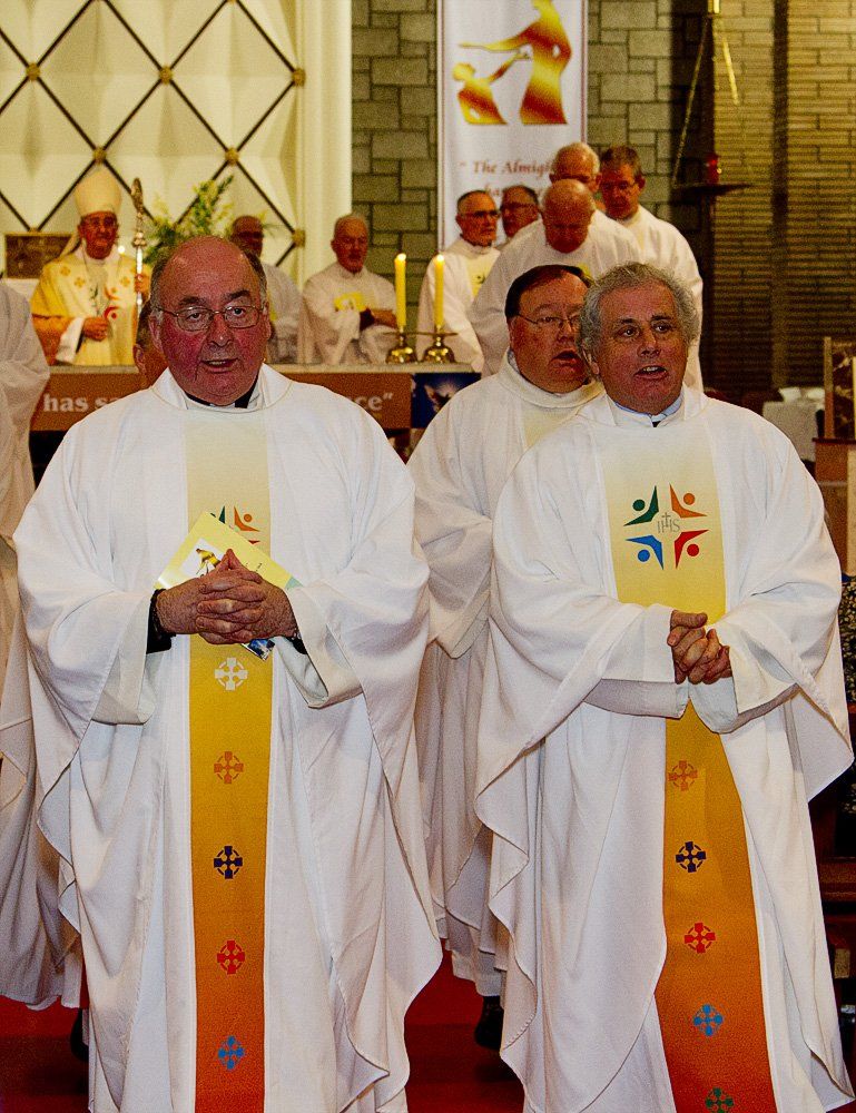 A group of priests are standing in a church