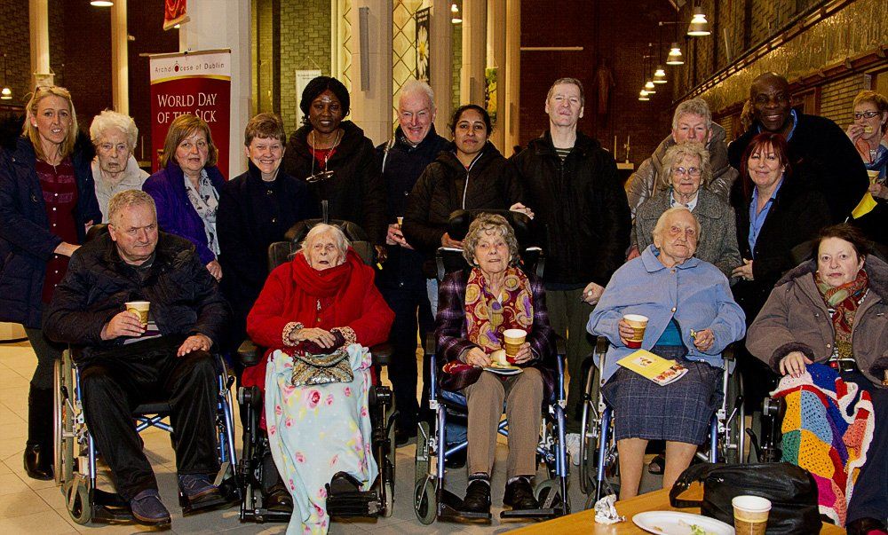 A group of people in wheelchairs are posing for a picture