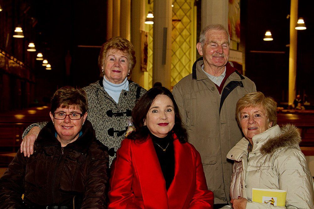A group of people are posing for a picture in a church.