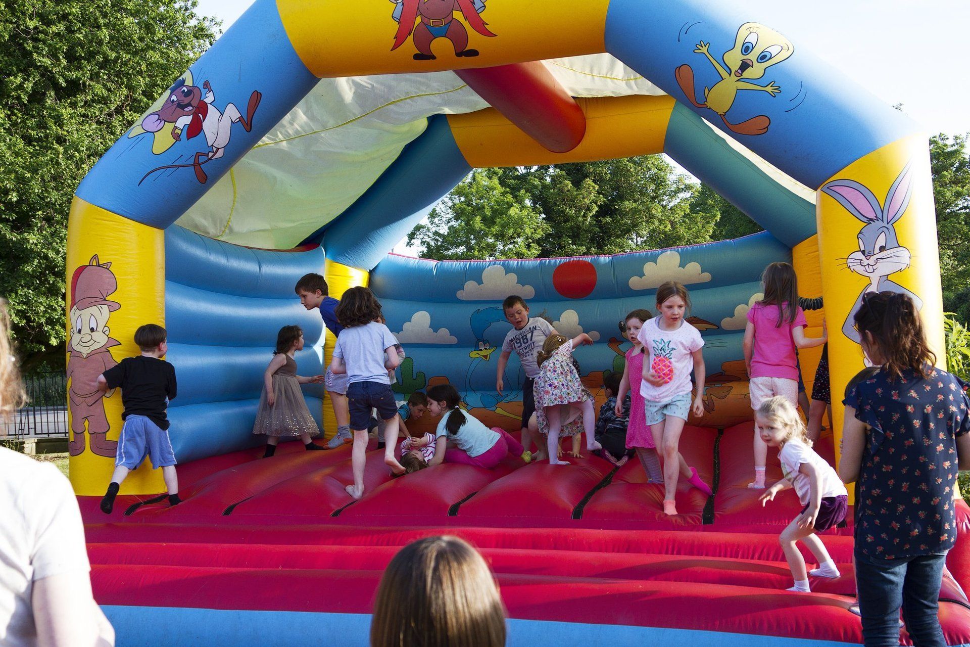 A group of children are playing in a bouncy house