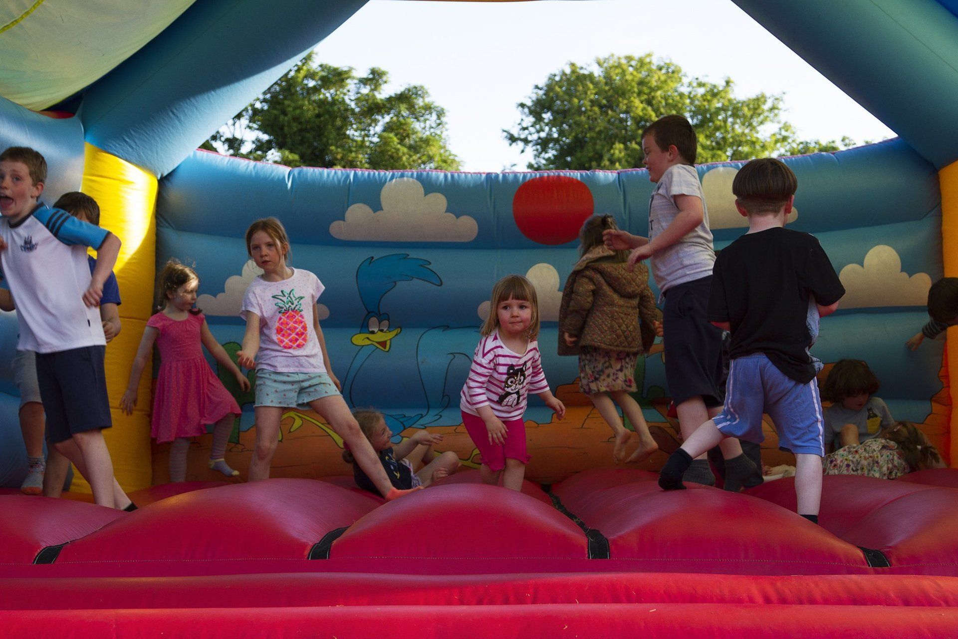 A group of children are playing in a bouncy house.