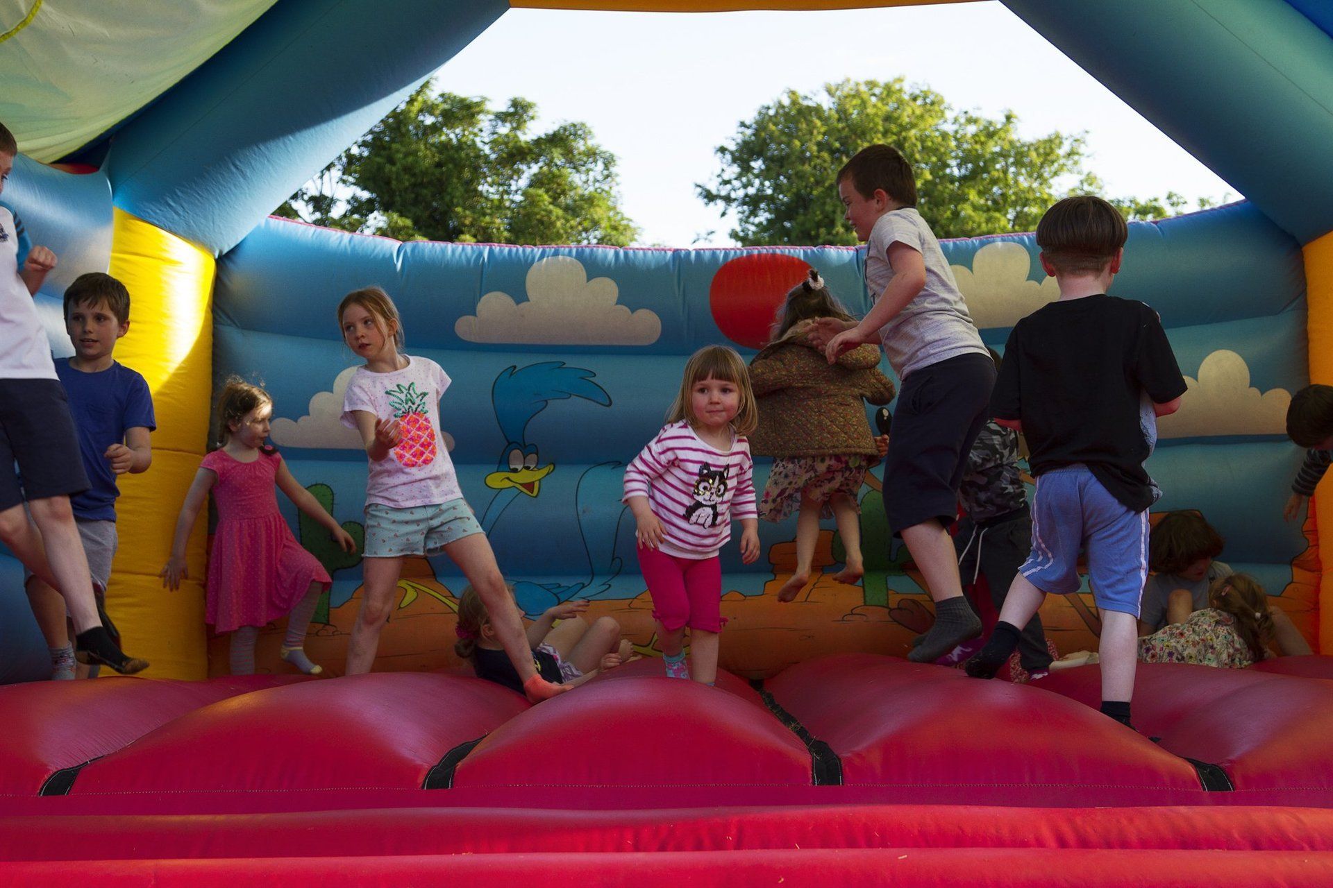 A group of children are playing in a bouncy house.