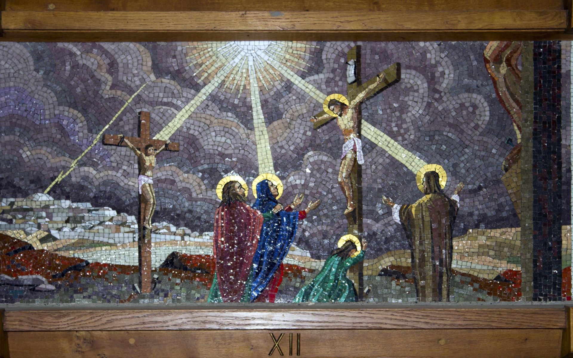 A painting of jesus on the cross with three people standing around him.